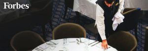 A waiter lays a table in the main dining hall on board the Royal Caribbean cruise ship.